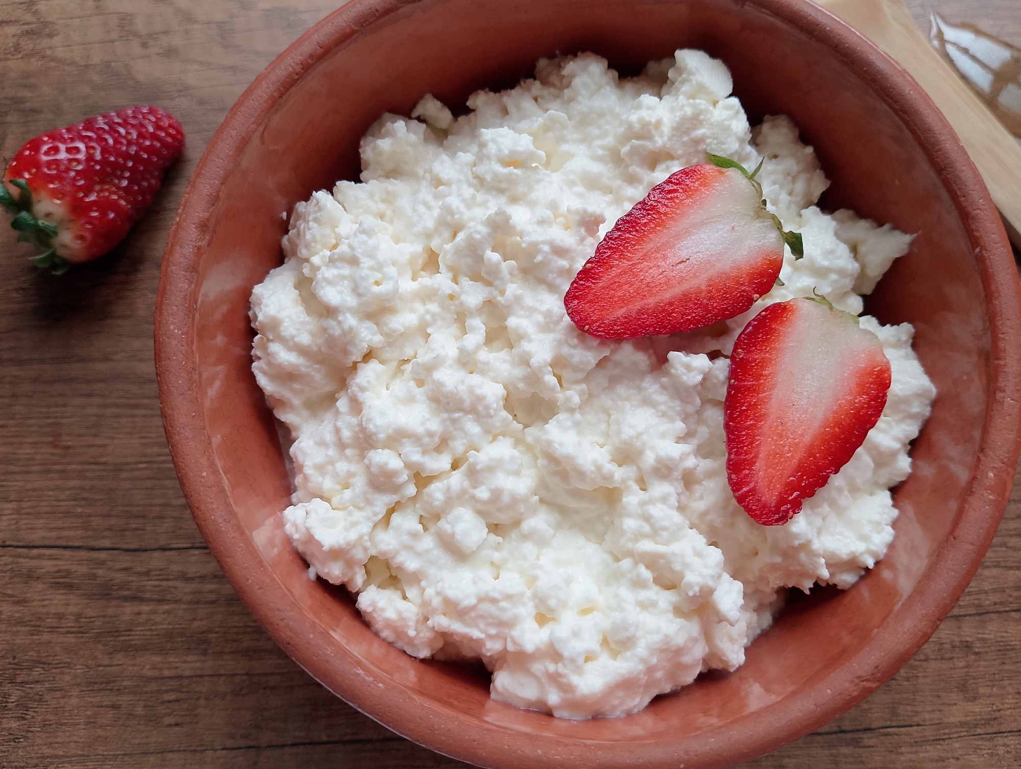 Homemade cottage cheese with soft creamy curds, made without rennet and served in a bowl