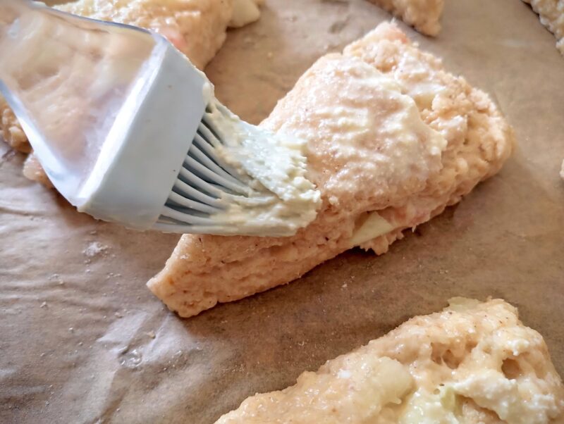 Brushing tops of scones with buttermilk
