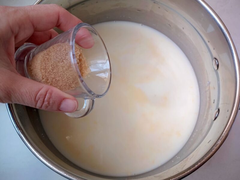 Adding sugar, cinnamon, and salt to warm milk