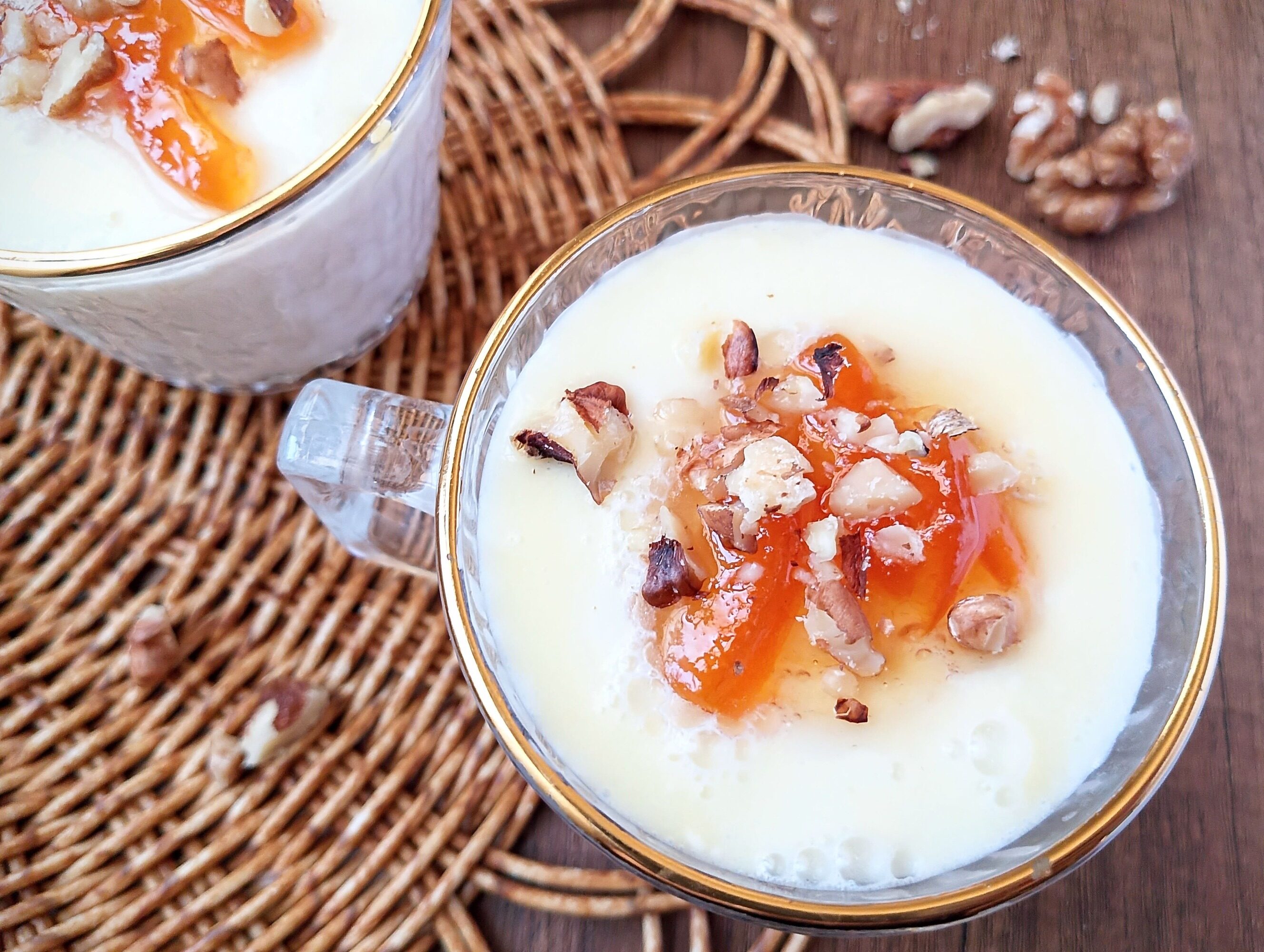 Creamy junket in cups, topped with marmalade and chopped walnuts