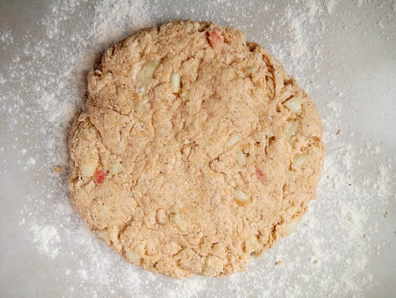 Patting scones dough into a circle on floured counter