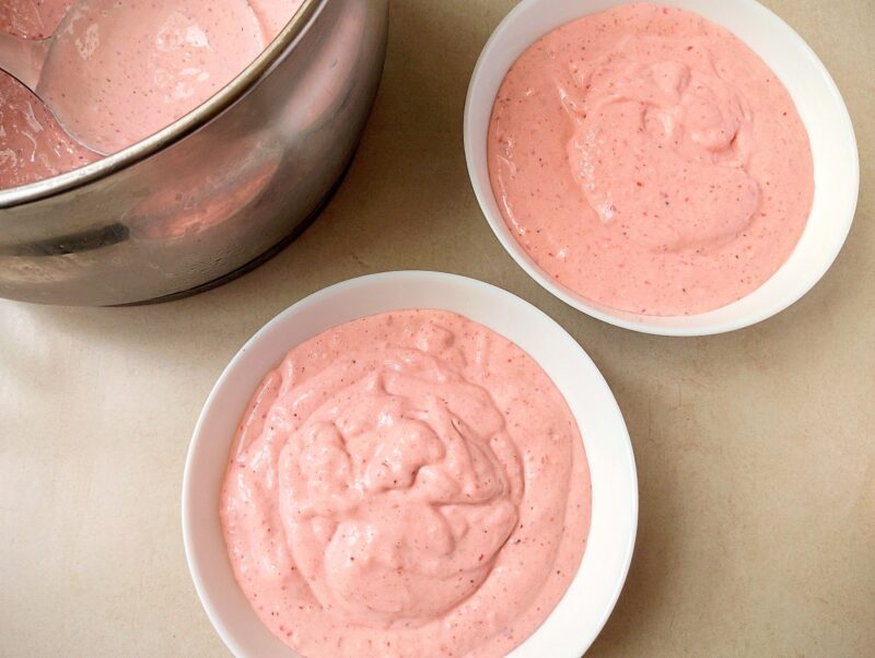 Pouring blended smoothie into serving bowls