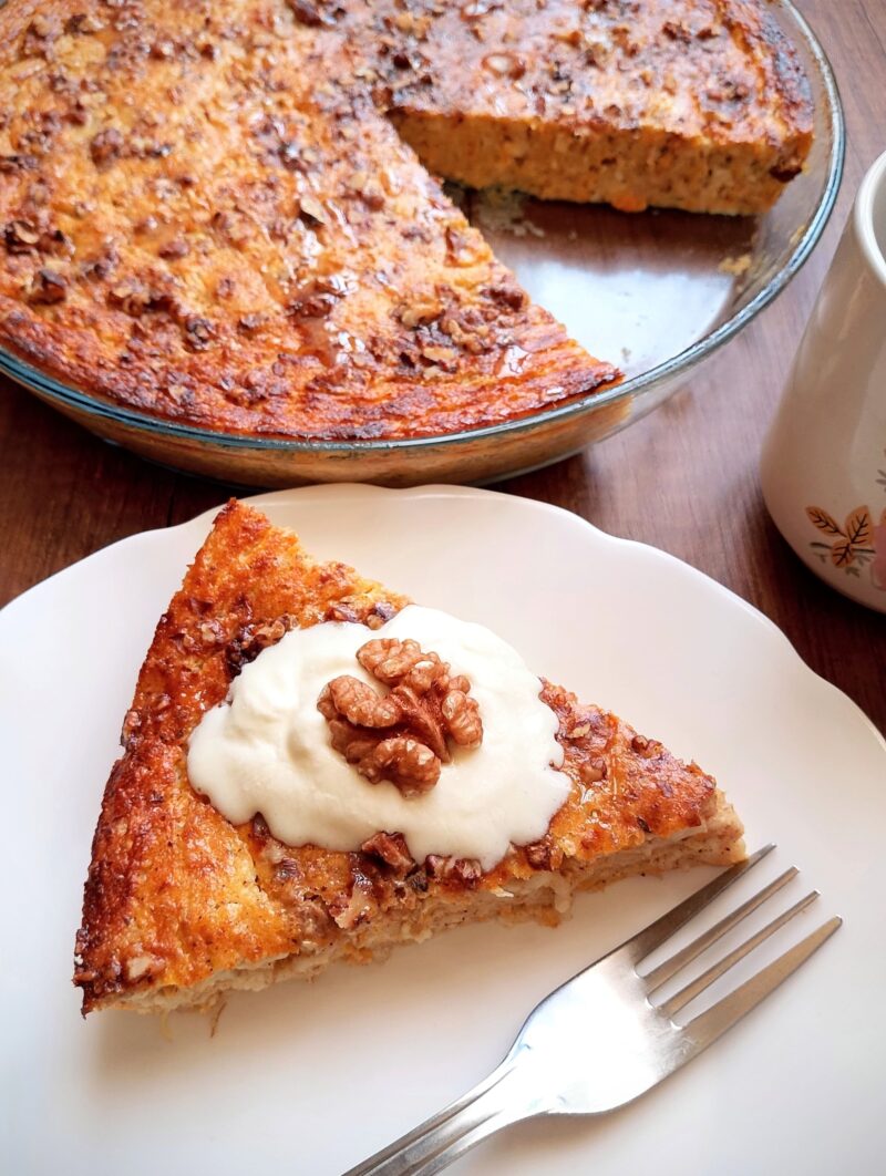 Cottage cheese pumpkin bake served on a plate and topped with whipped cream and a walnut