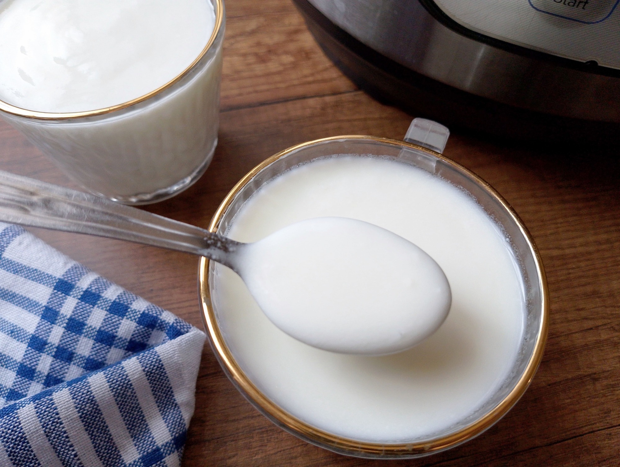 Spoon lifting some Instant Pot yogurt from a serving cup