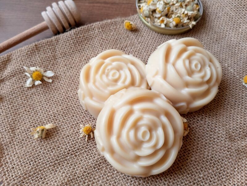 Tallow lotion bars on burlap with dried chamomile flowers around