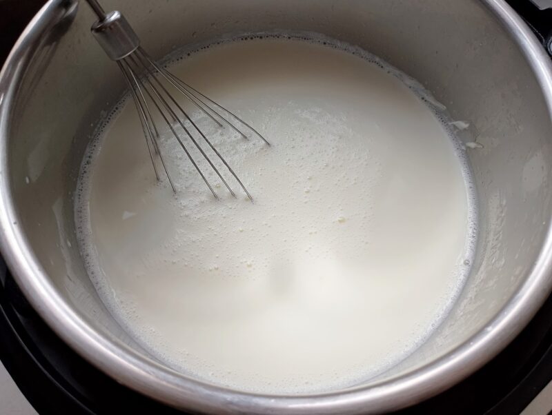 Whisking yogurt starter into warm milk in insant pot
