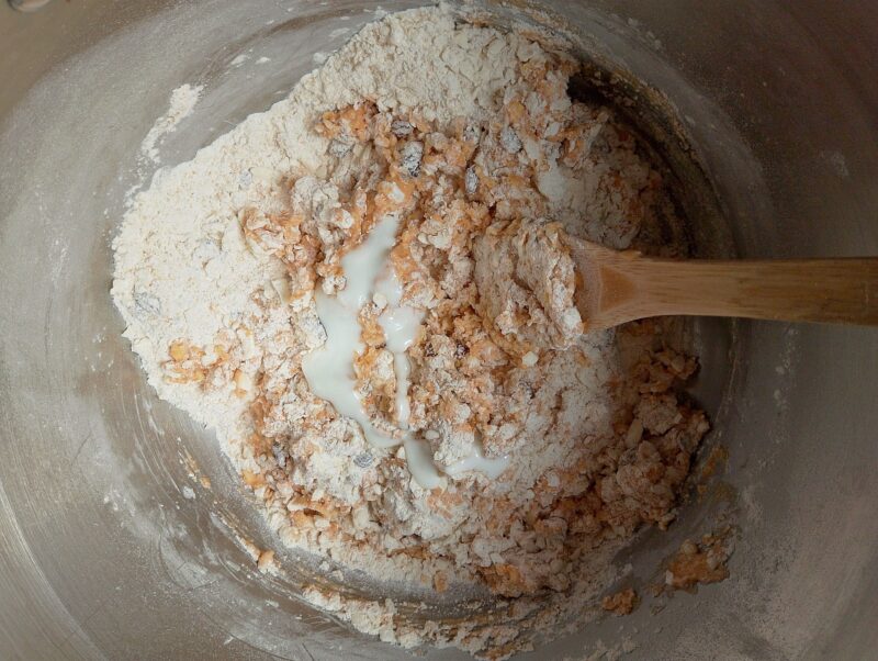 Adding wet ingredients into dry ingredients in bowl