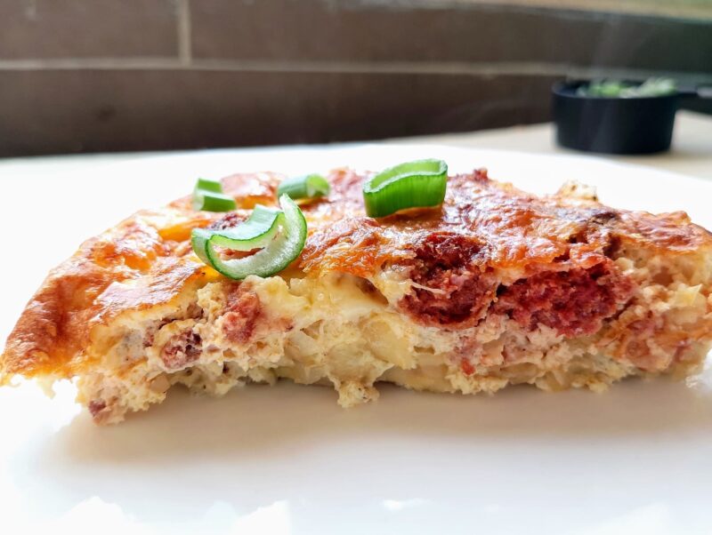 Slice of Amish breakfast casserole on white plate