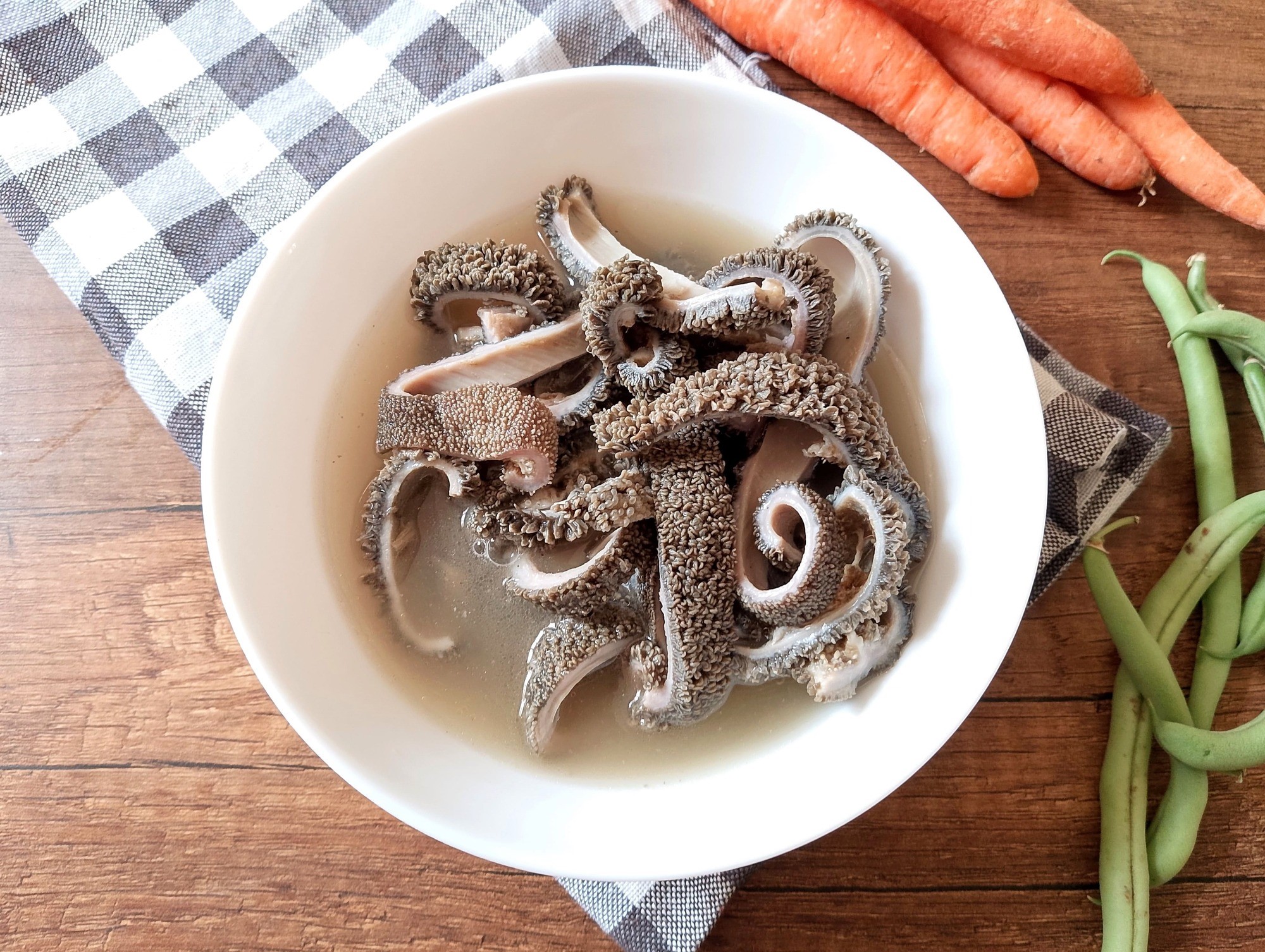 How to cook tripe in instant pot: cooked tripe sliced into strips, served in a bowl with some broth