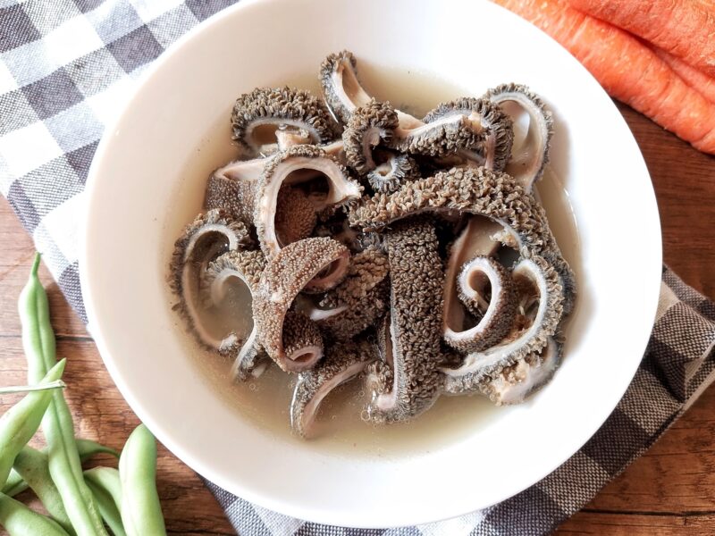 Cooked blanket tripe, sliced into strips and served in bowl with a little broth