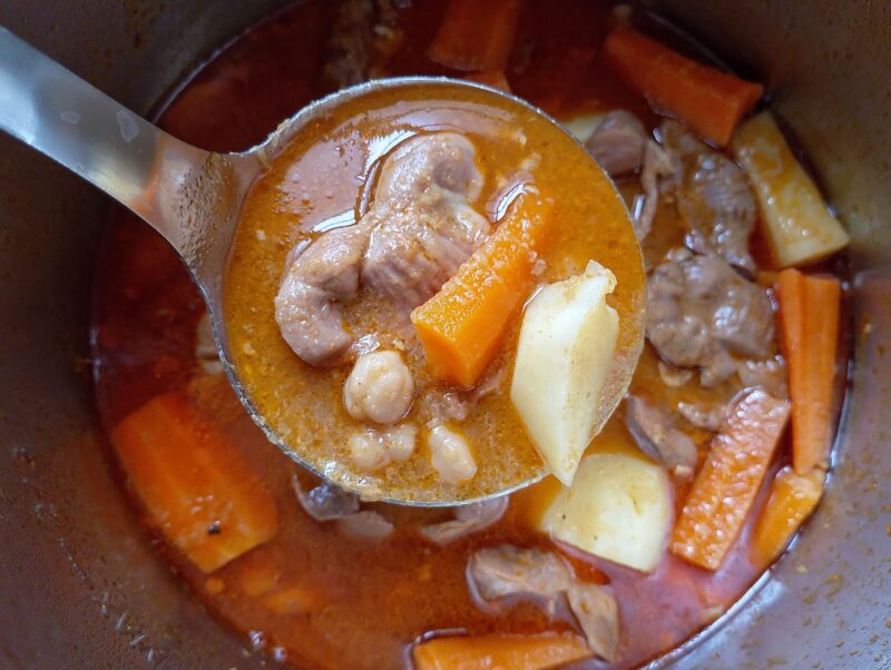 Ladling gizzard tagine out of the instant pot