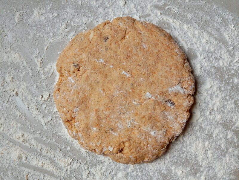 Shaping scones dough into circle on floured counter