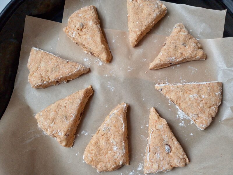 Unbaked scones on lined baking sheet