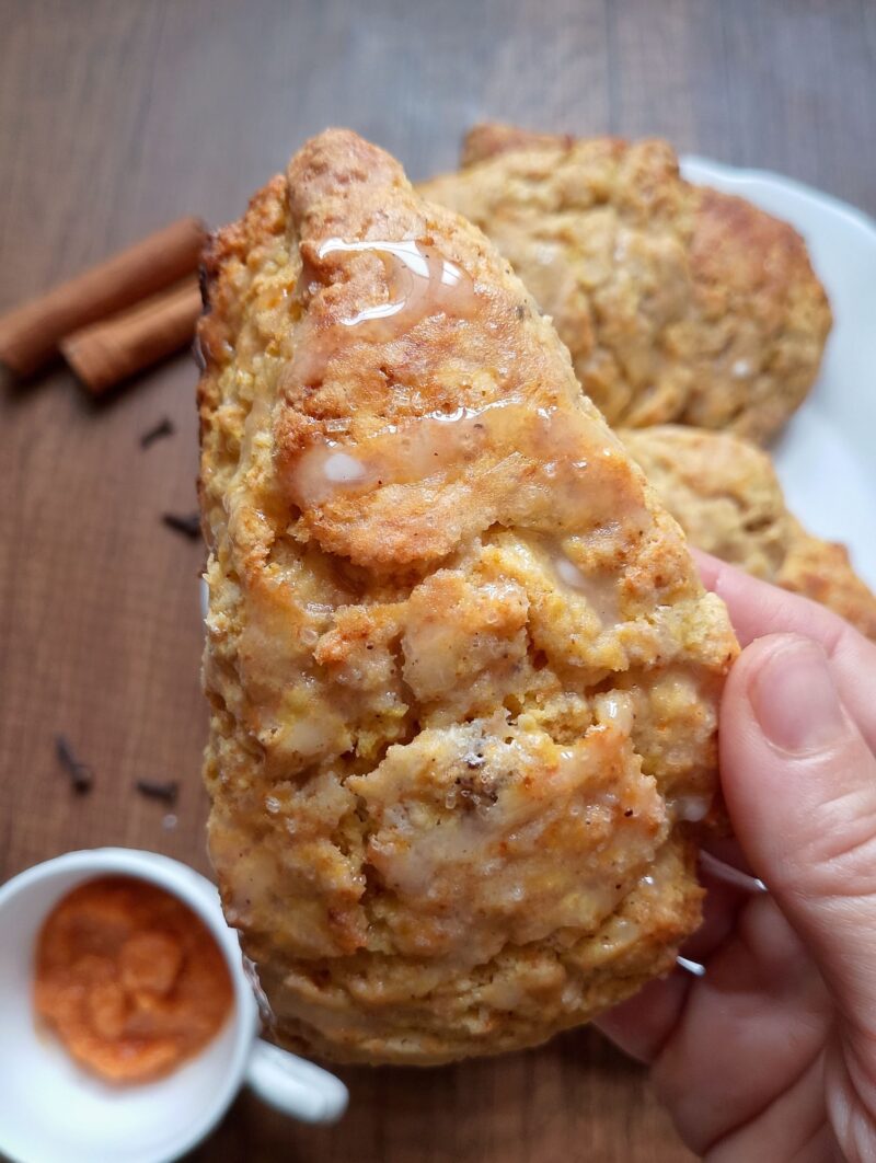 Woman's hand holding a sourdough pumpkin scone