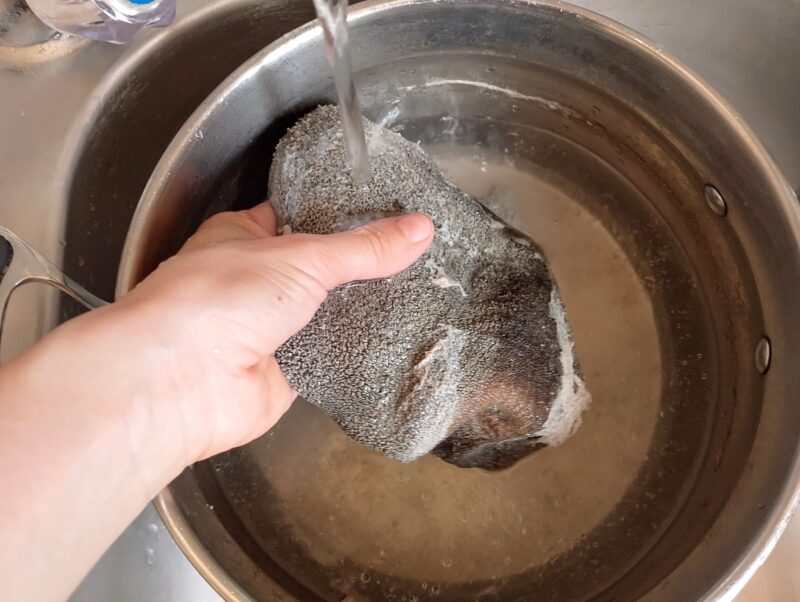 Rinsing parboiled tripe under running water