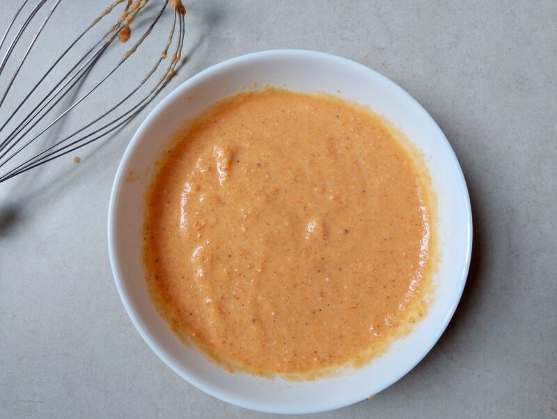 Mixing wet ingredients for pumpkin scones in a bowl