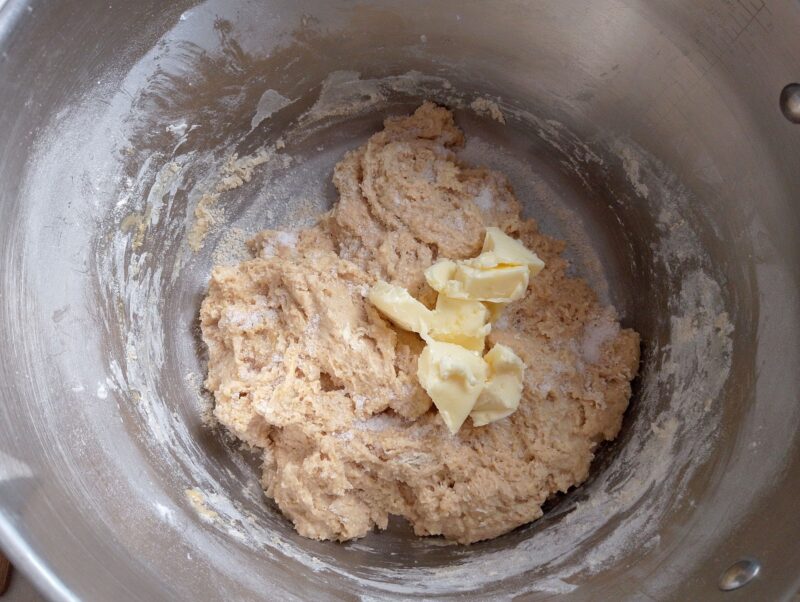 Adding butter and salt to dough