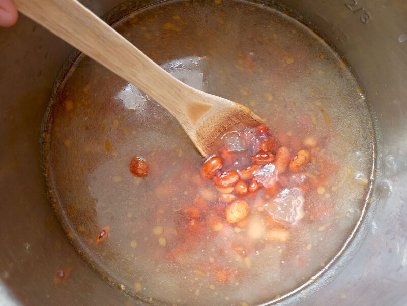 Adding soaked beans, broth, and water to instant pot