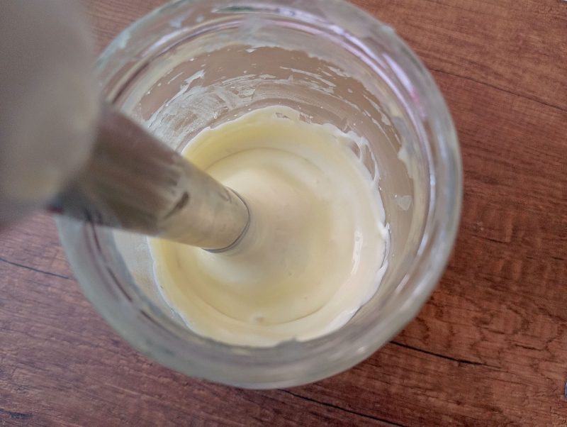 Blending calendula body butter with immersion blender