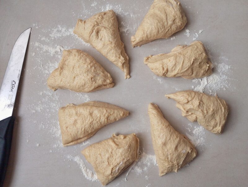 Dividing dough into pieces on floured counter