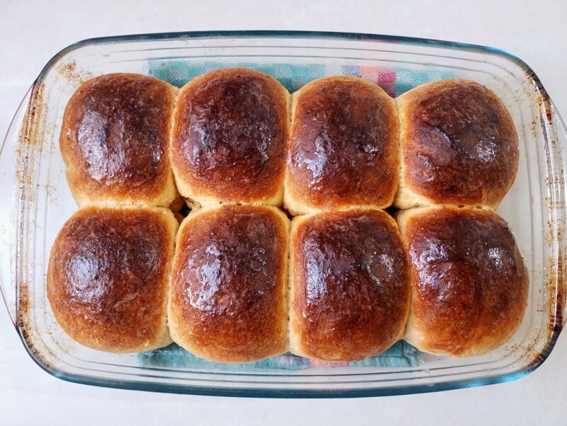 Freshly baked soft sourdough rolls glazed with melted butter
