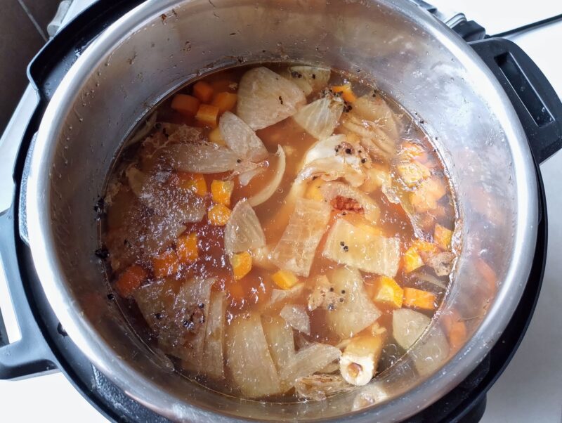 Finished lamb bone broth cooling in pot