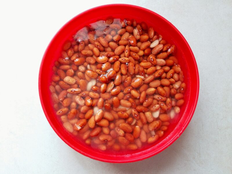 Pinto beans soaking in water in a bowl